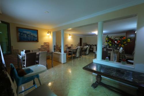 a restaurant with a dining room with tables and chairs at Hotel Harmony in Kutaisi