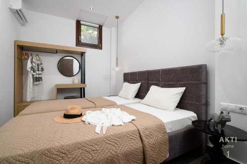 a bedroom with a bed with a hat and towels on it at AKTI Homes Matala in Matala