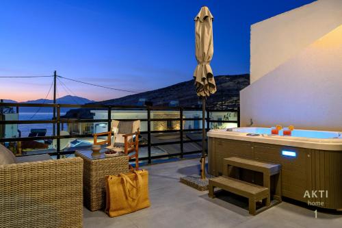 a balcony with a tub and a view of the ocean at AKTI Homes Matala in Matala
