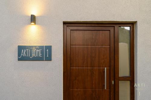 a door with a sign above it next to a building at AKTI Homes Matala in Matala