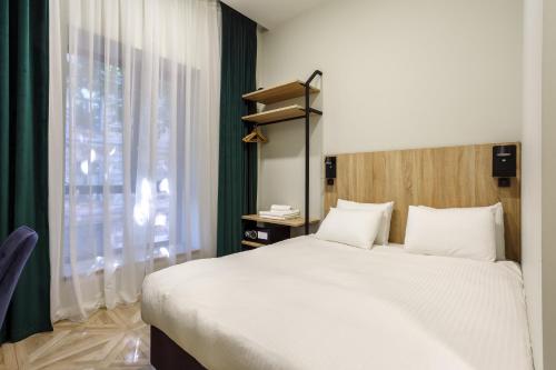 a bedroom with a large bed and a window at Lito hotel in Odesa