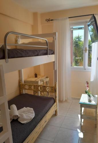 a room with two bunk beds and a window at Agros house in Ermoupoli