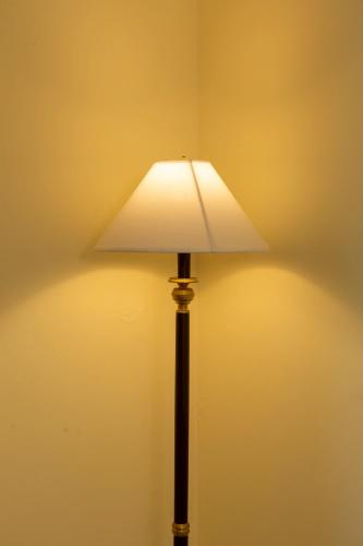a lamp with a white shade on a wall at CS Pattani Hotel in Ban Ru Sa Mi Lae