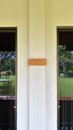 a wooden sign on the side of a building at Serenity1 Homestay in Chiang Dao