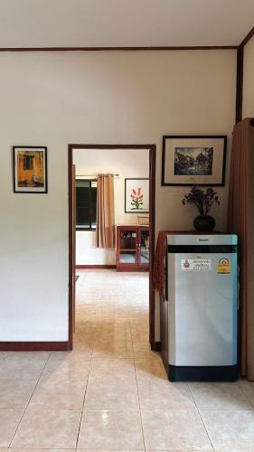 a living room with a refrigerator and a mirror at Serenity1 Homestay in Chiang Dao