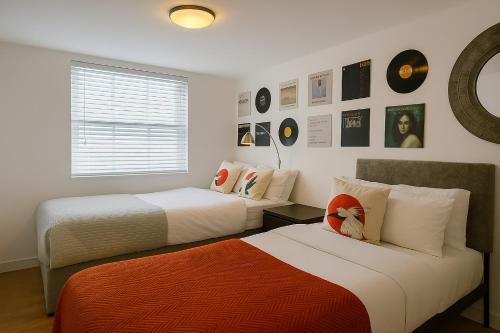 a bedroom with two beds and a window at Sidemersey Livings - Spacious Loft for bigger groups - Very Central and Cosy in Liverpool