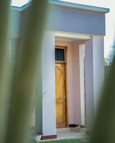 a door of a house with a plant in front of it at Advem Villa in Dodoma