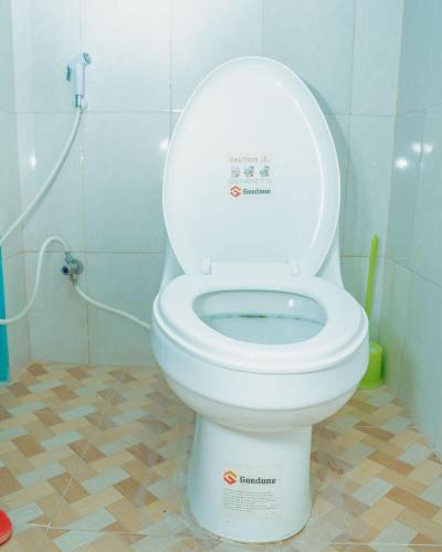 a bathroom with a toilet with the lid up at Advem Villa in Dodoma