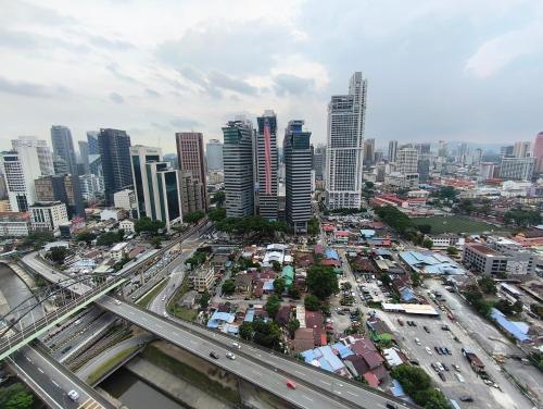 an overhead view of a city with traffic at Summer Suites KLCC by CozyNest in Kuala Lumpur