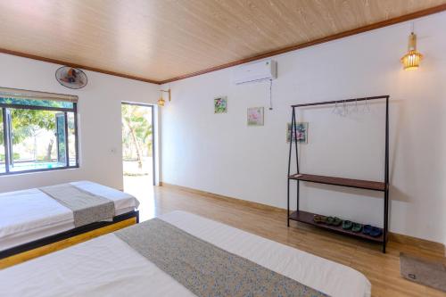 a bedroom with two beds and a mirror at Ninh Binh Footprint Homestay in Ninh Binh