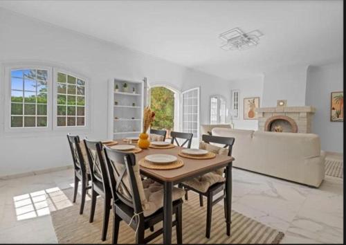 a dining room with a table and chairs and a fireplace at Premium house in Mougins with Private Tennis in Mougins