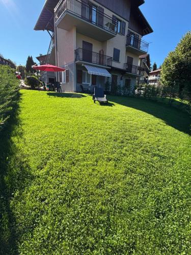 a large grassy yard in front of a building at Riki House Selvino in Selvino