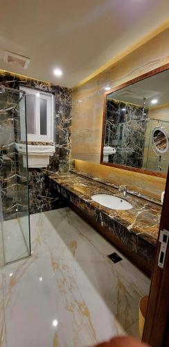 a bathroom with a sink and a mirror at Peace House II in Islamabad