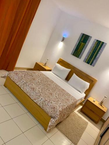 Una cama o camas en una habitación de condomínio vila verde Pepper T0 e T1