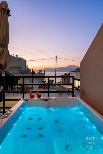 a hot tub on a balcony with a view of the ocean at AKTI Homes Matala in Matala