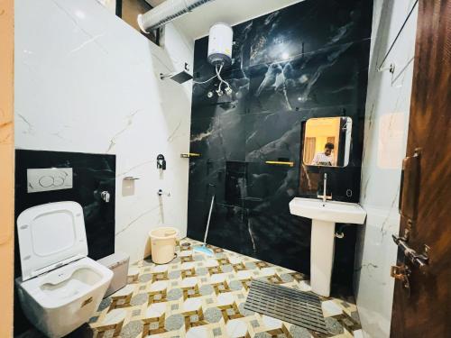 a bathroom with a toilet and a sink at Live Free Hostel Dehradun in Dehradun