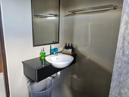 a bathroom with a sink and a mirror and a shower at DB Studios Samui - Adults Only in Lamai