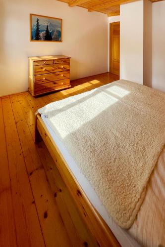 a bedroom with a large bed and a wooden dresser at Chalupa Helena in Vítkovice