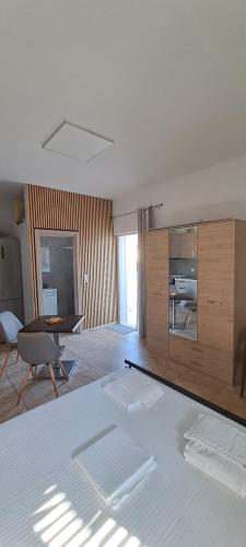 a room with a bed and a desk and a table at EVA'S Home in Korissia