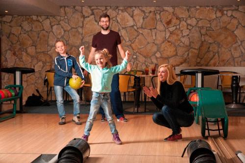 a group of people playing a game of bowling at Szent Orbán Erdei Wellness Hotel és Residence in Kóspallag