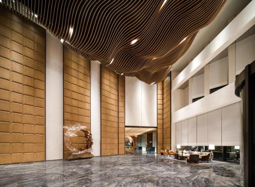 a lobby of a hotel with couches and chairs at Pullman Chongqing Xiyue in Chongqing