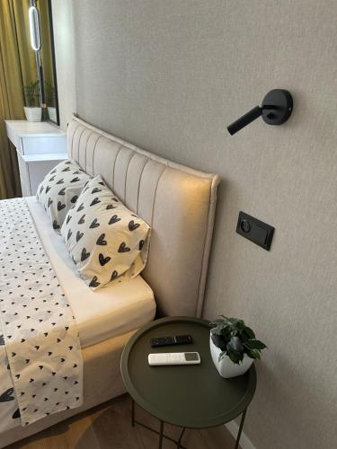 a small bedroom with a bed and a table at My bee apt in Kremenchuk