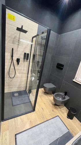 a bathroom with a shower and a toilet at Suite del Corso in Ficarazzi