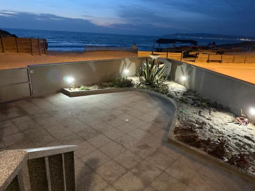 a patio with a view of the ocean at night at Home in Paradise Costa de Lavos in Costa de Lavos