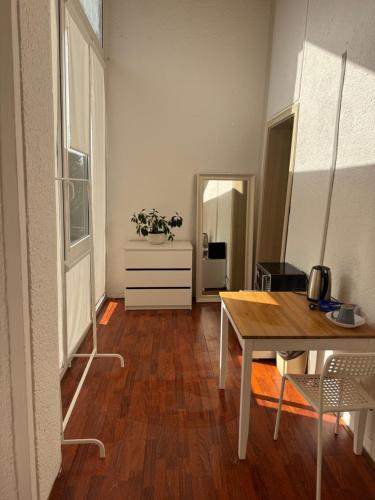 a living room with a table and a dining room at Saules namu kambariukas in Palanga