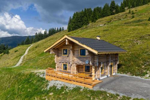 a log cabin on top of a hill at Bergerhof Alpin Lodge in Neukirchen am Großvenediger