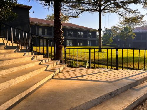 a black fence with stairs in front of a building at Royal Solwezi Hotel in Solwezi