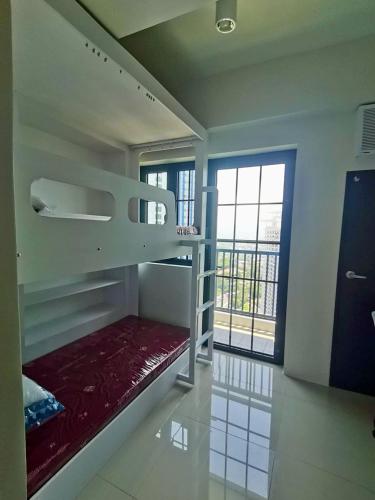 a room with a bunk bed and a window at Dorm in Katipunan - Upper Bunk Bed in Manila