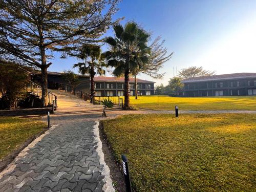 a cobblestone path in front of a building at Royal Solwezi Hotel in Solwezi