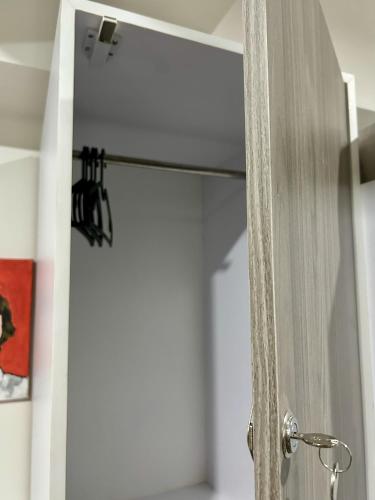 a wooden door with a mirror in a room at Dorm in Katipunan - Upper Bunk Bed in Manila