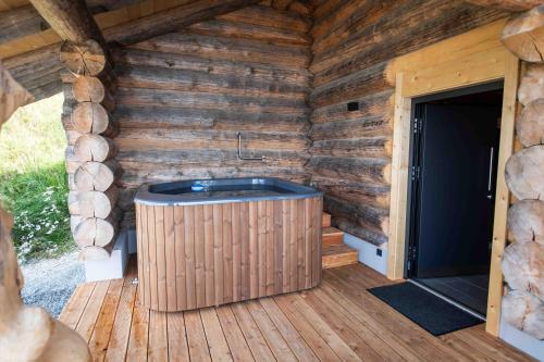 a jacuzzi tub in a log cabin at Bergerhof Alpin Lodge in Neukirchen am Großvenediger