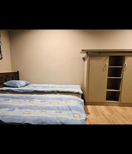 a bedroom with two beds and a closet at Lipowa Guest House in Bielawa