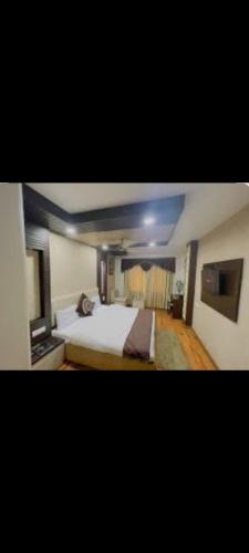 a bedroom with a large bed in a room at Sai hotel in Morādābād