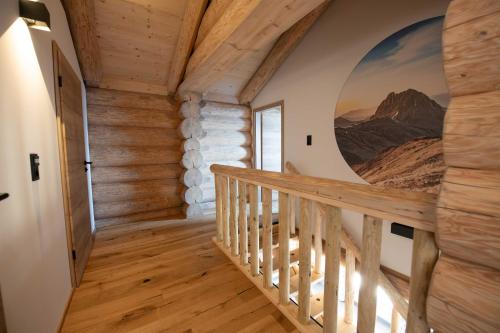 a staircase in a house with a painting on the wall at Bergerhof Alpin Lodge in Neukirchen am Großvenediger