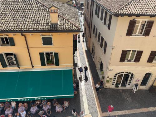 an overhead view of a group of people in a street between buildings at Palazzo Betteloni in Bardolino