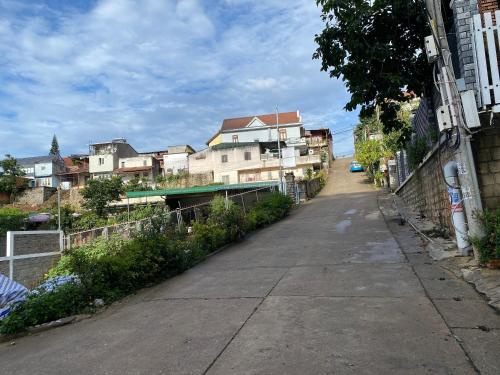 an empty street in a city with buildings at Sleep Box Anlina Đường 3 Tháng 4 in Xuan An