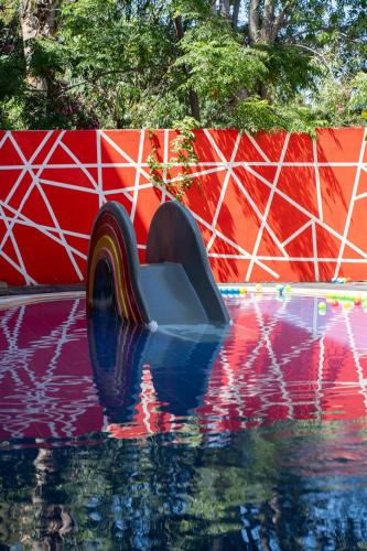 a pool of water with a slide in the middle at Blue Dreams Resort Bodrum - Aquapark & Ultra All Inclusive in Torba