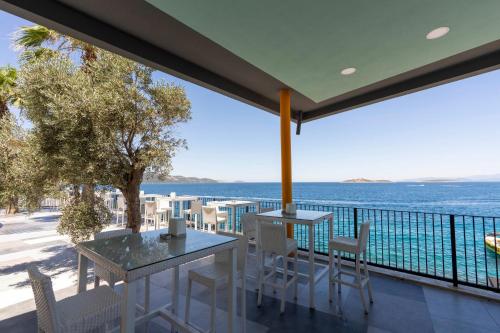 a balcony with a table and chairs and the ocean at Blue Dreams Resort Bodrum - Aquapark & Ultra All Inclusive in Torba