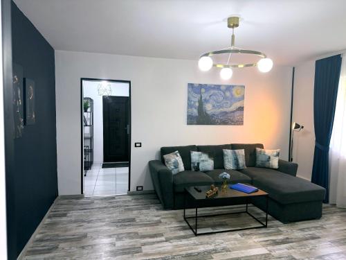 a living room with a couch and a table at Comfort Apartment in Târgovişte