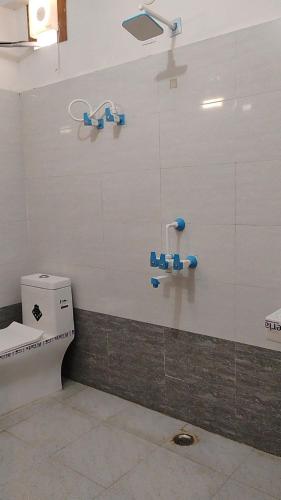a bathroom with a toilet in a room at Hotel Aligarh Inn in Alīgarh