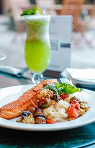 a plate of food on a table with a drink at Sheraton Pilar Hotel & Convention Center in Pilar