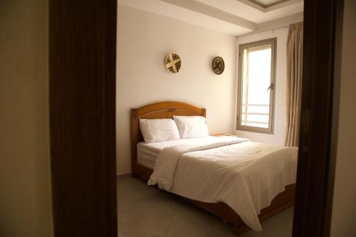 a bedroom with a bed and a window at Surf and Stay Villa Anza Taghazout Tamraght in Agadir