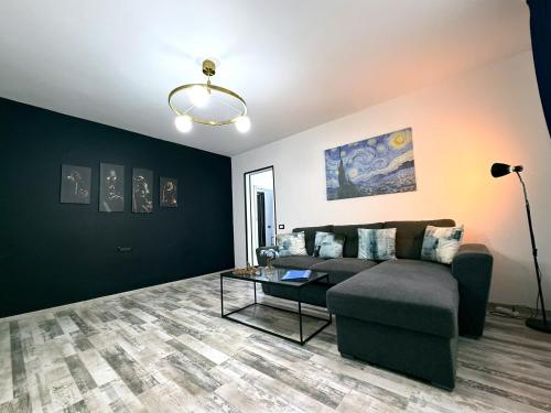 a living room with a couch and a table at Comfort Apartment in Târgovişte