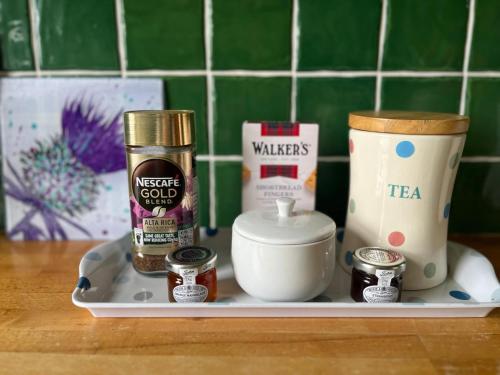 a tray with various products on a counter at Midkinleith Farm Holiday Cottage in Edinburgh