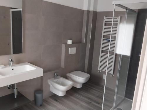 a bathroom with a toilet and a sink and a shower at The View 2 in Teglio