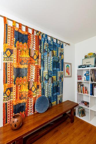 a curtain in a room with a wooden table at Trendy Bohemian Bungalow, Close to Uptown, Plaza & Noda in Charlotte